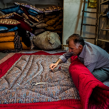 Making a quilt at bazaar of Yazd